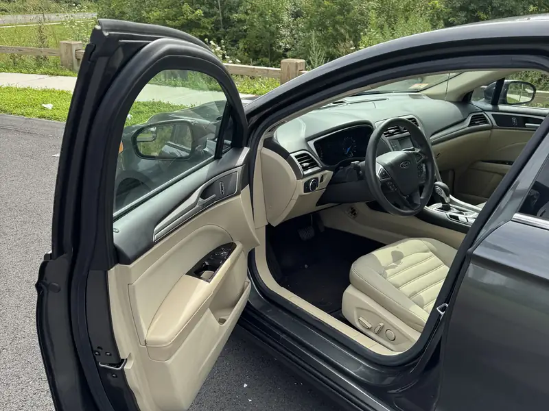 Ford Fusion: Driver's door open, front seats
